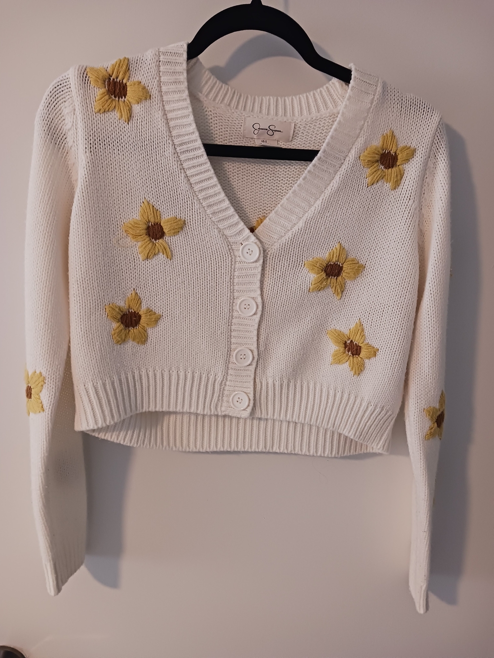 Jessica Simpson Cream Cropped V‑Neck Cardigan with Yellow Floral Embroidery